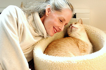 Image showing Female and kitten bonding.