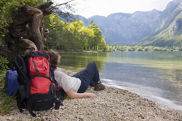 Image showing Female hiker resting at a mountain lake