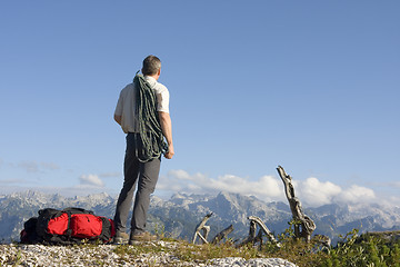 Image showing Mountaineer with rope on mountain peak