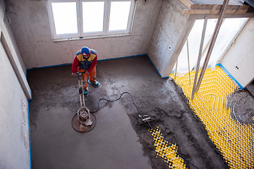 Image showing worker performing and polishing sand and cement screed floor