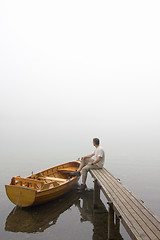 Image showing Man at a lake on misty morning