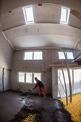 Image showing worker performing and polishing sand and cement screed floor