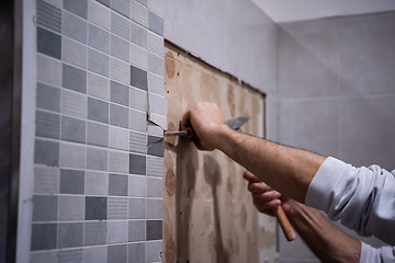 Image showing worker remove demolish old tiles in a bathroom