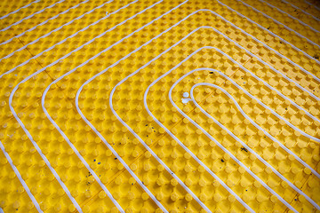 Image showing yellow underfloor heating installation with white pipes