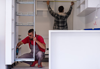 Image showing workers installing a new kitchen