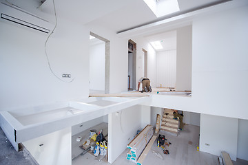 Image showing Worker Installing New Laminated Wooden Floor