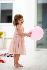 Image showing cute little girl playing with balloons