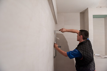 Image showing professional plumber working in a bathroom