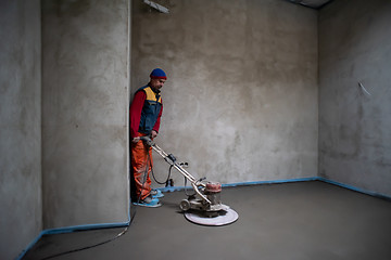 Image showing worker performing and polishing sand and cement screed floor