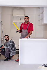 Image showing young workers installing a new kitchen