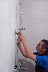 Image showing professional plumber working in a bathroom