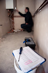 Image showing engineer checking technical data of heating system