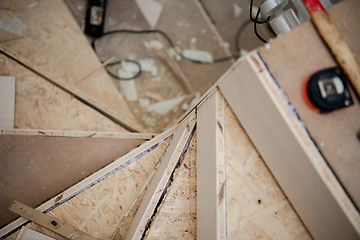 Image showing work in progress on stylish interior with wooden stairs