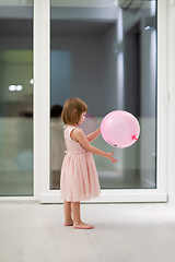 Image showing cute little girl playing with balloons