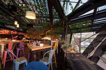 Image showing blurred people in cafe decorate with hanging plant