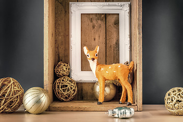 Image showing Christmas decoration wooden box with deer golden balls and a whi