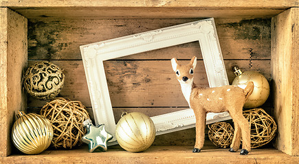 Image showing Christmas decoration wooden box with deer golden balls and a whi