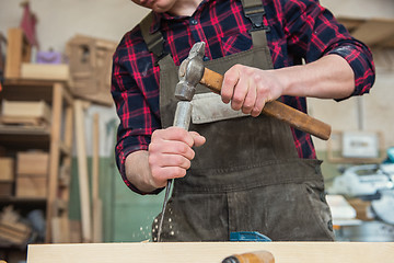 Image showing Carpenter working with a chisel