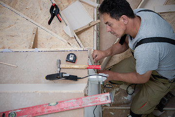 Image showing carpenter installing wooden stairs