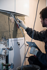 Image showing Worker plastering the wall by concrete