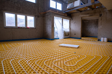 Image showing yellow underfloor heating installation with white pipes