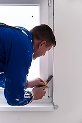 Image showing construction worker plastering on gypsum walls