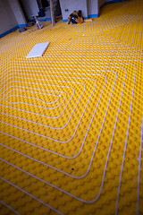 Image showing yellow underfloor heating installation with white pipes