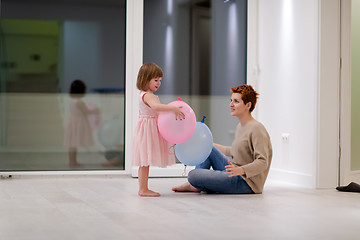 Image showing mother and cute little daughter playing with balloons