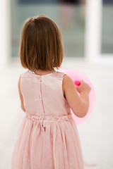 Image showing cute little girl playing with balloons