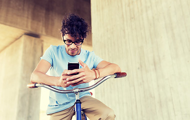 Image showing man with smartphone and fixed gear bike on street