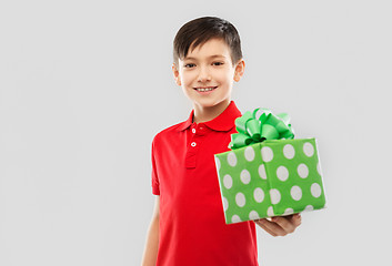 Image showing smiling boy in red t-shirt with birthday gift box