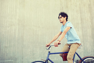 Image showing young hipster man riding fixed gear bike