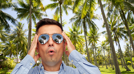 Image showing surprised man in sunglasses over tropical beach