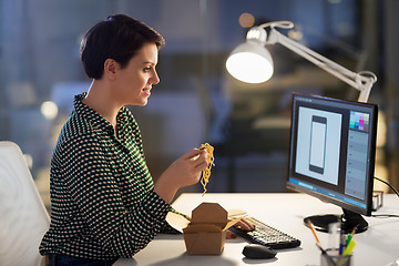 Image showing female designer eating and working at night office