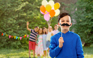 Image showing happy boy with black moustaches at birthday party