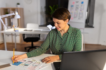 Image showing woman working on user interface at night office