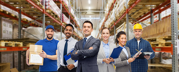 Image showing group of business people and warehouse workers