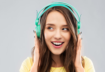 Image showing happy young woman or teenage girl with headphones