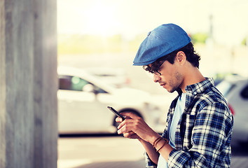 Image showing hipster man texting message on smartphone