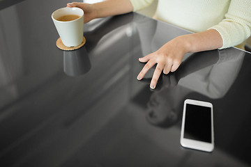 Image showing woman with coffee using black interactive panel