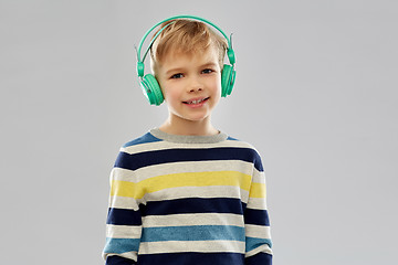 Image showing smiling boy in headphones listening to music