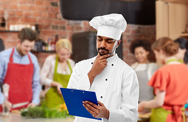 Image showing chef with menu on clipboard at cooking class