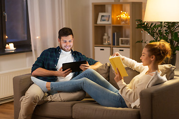 Image showing couple with tablet computer and book at home