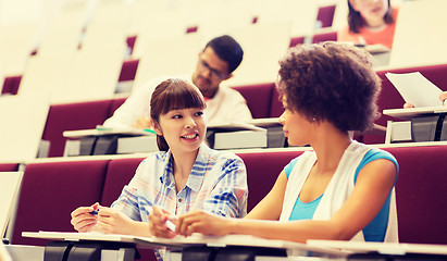Image showing group of students talking in lecture hall