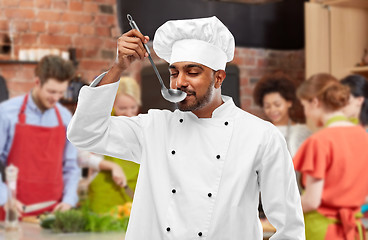 Image showing chef tasting food from ladle at cooking class