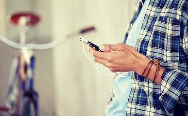 Image showing man with earphones and smartphone listening music