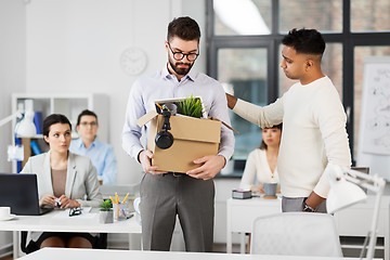 Image showing colleague seeing off sad fired male office worker