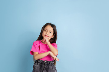 Image showing Caucasian little girl\'s portrait on blue studio background