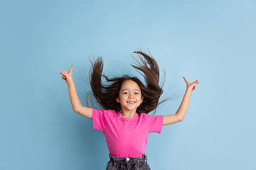 Image showing Caucasian little girl\'s portrait on blue studio background