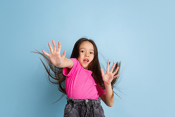 Image showing Caucasian little girl\'s portrait on blue studio background